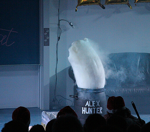 A fountain of foam comes out of a barrel on stage.