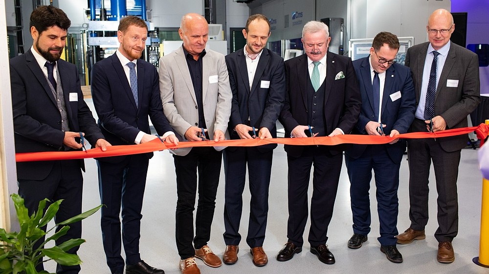Official guests cut a ribbon.