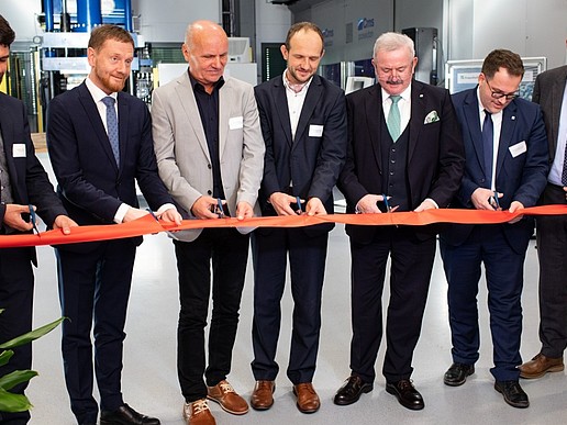 Official guests cut a ribbon.