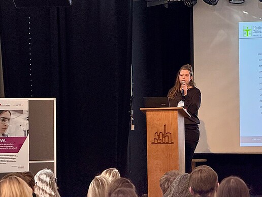 [Bernadette Rohlf at the lectern
