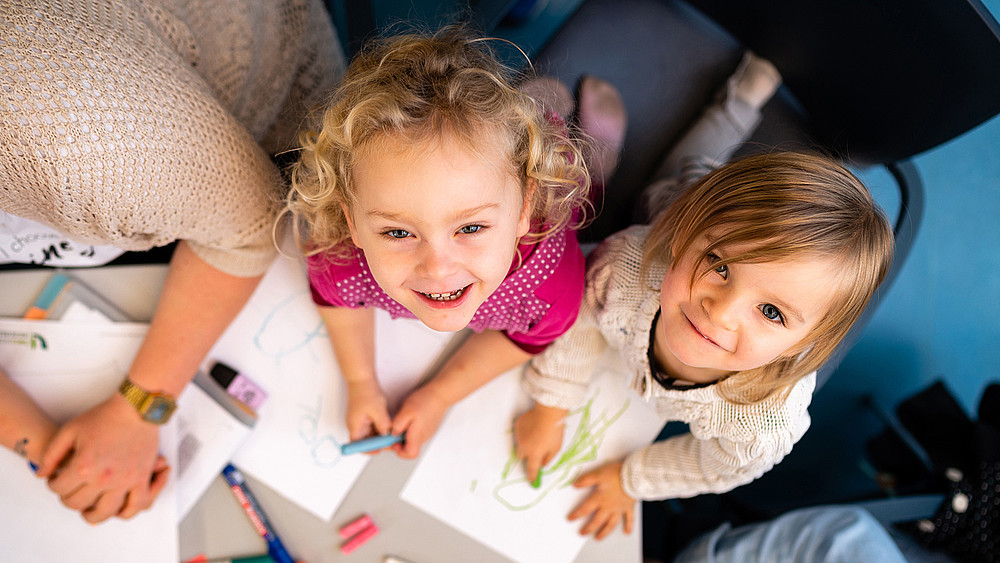 Two kindergarten children as a symbol of childhood education in times of the coronavirus pandemic.
